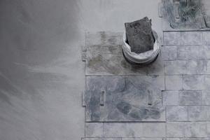 Worker working on gray concrete stamping floor at the construction agency photo