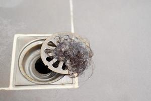 clogged pipe, anti-odor strainer with foul-smelling garbage in the bathroom photo