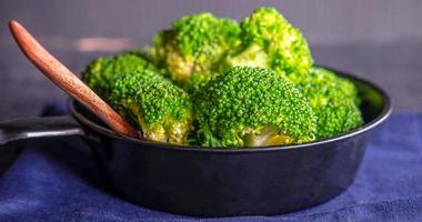 Close-up of green fresh vegetable broccoli. Fresh green broccoli on a pan. Broccoli vegetable is full of health. Vegetables for diet and healthy eating.Top view photo