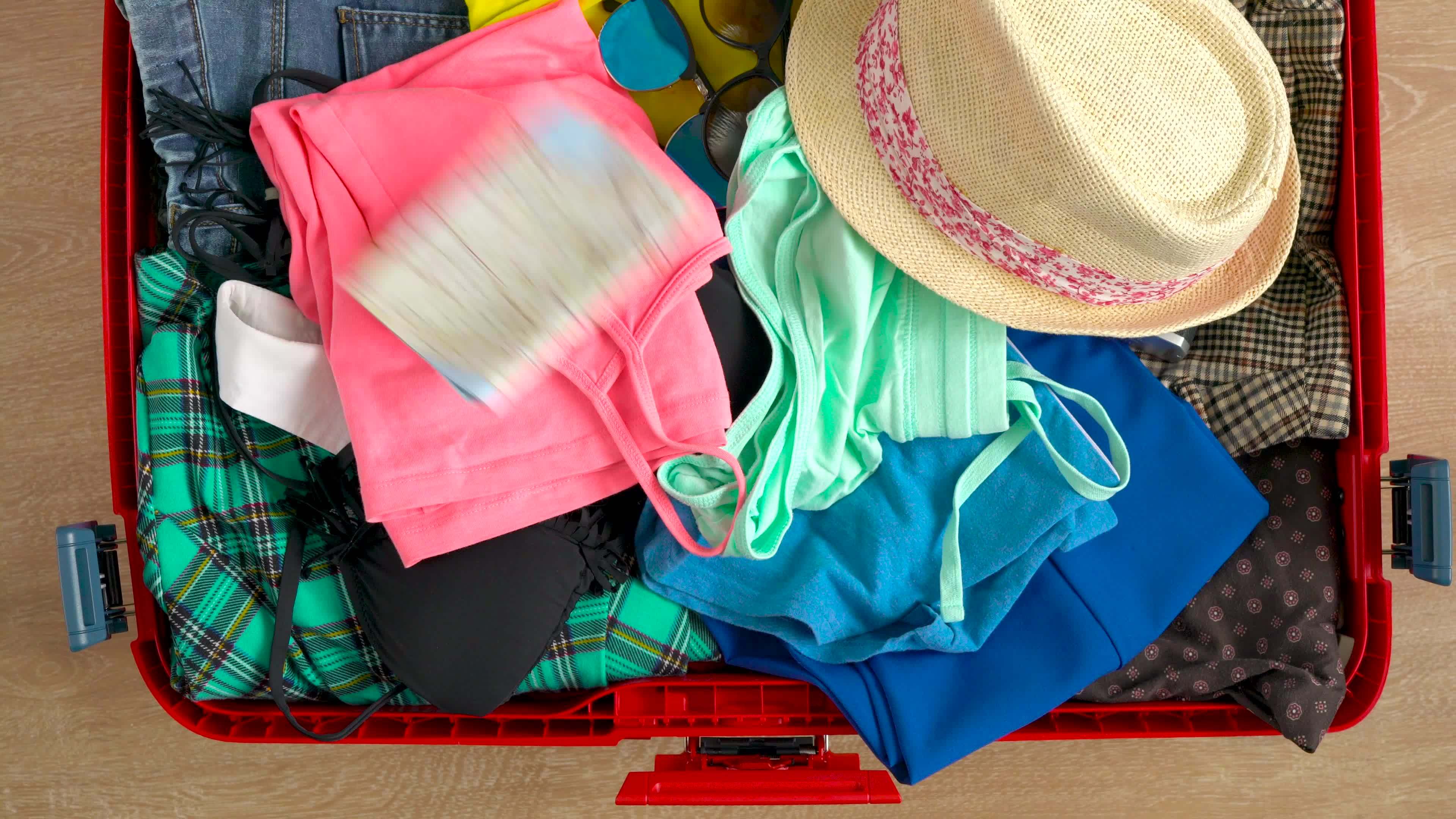 Things are falling into a suitcase, and the suitcase is closed. 21852805 Stock Video at Vecteezy