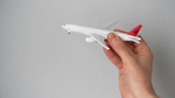 Toy airplane in the hand simulates a flight video