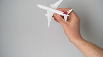 Toy airplane in the hand simulates a flight video