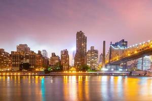 Manhattan city skyline cityscape of New York with Queen Bridge photo