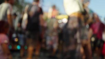 Shot of a crowd moving through a funfair in blur and soft focus video