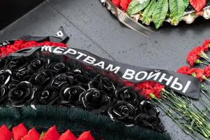 A wreath with a mourning ribbon to the victims of the war is laid on the monument photo