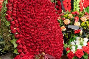 A wreath of red living roses is laid at the monument on the street. Day of Remembrance and Sorrow. photo