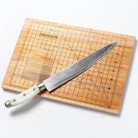 corte tablero con un medición herramienta y un cuchillo en eso foto
