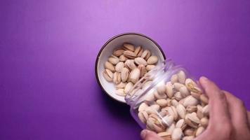 pouring pistachios nut from a jar, Top view video