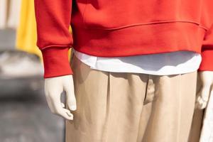 part of mannequin dressed in casual clothes. shelf display in shop mall store. Store Of Shopping Center. photo