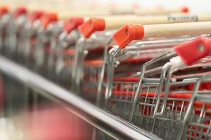 row of shopping trolleys or carts in supermarket.