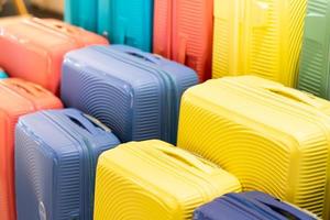 Stylish suitcases on color background. Packed travel colorful suitcases. Many multi colored big suitcases or luggage. photo