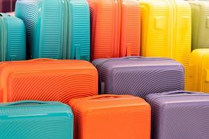 Stylish suitcases on color background. Packed travel colorful suitcases. Many multi colored big suitcases or luggage. photo