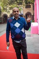 New Delhi, India - December 04 2022 - Unidentified people showing their ink-marked fingers after casting votes in front of polling booth of east Delhi area for MCD local body Elections 2022 photo