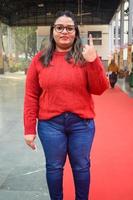 New Delhi, India - December 04 2022 - Unidentified people showing their ink-marked fingers after casting votes in front of polling booth of east Delhi area for MCD local body Elections 2022 photo