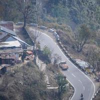 Aerial top view of traffic vehicles driving at mountains roads at Nainital, Uttarakhand, India, View from the top side of mountain for movement of traffic vehicles photo