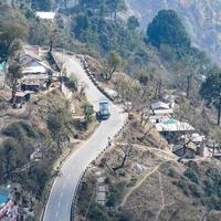 Aerial top view of traffic vehicles driving at mountains roads at Nainital, Uttarakhand, India, View from the top side of mountain for movement of traffic vehicles photo