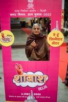 New Delhi, India - December 04 2022 - Unidentified people showing their ink-marked fingers after casting votes in front of polling booth of east Delhi area for MCD local body Elections 2022 photo