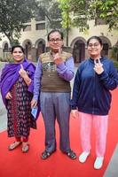 New Delhi, India - December 04 2022 - Unidentified people showing their ink-marked fingers after casting votes in front of polling booth of east Delhi area for MCD local body Elections 2022 photo