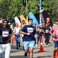 New Delhi, India - October 16 2022 - Vedanta Delhi Half Marathon race after covid in which marathon participants about to cross the finish line, Delhi Half Marathon 2022 photo