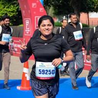 New Delhi, India - October 16 2022 - Vedanta Delhi Half Marathon race after covid in which marathon participants about to cross the finish line, Delhi Half Marathon 2022 photo