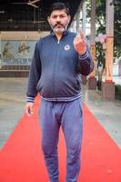 New Delhi, India - December 04 2022 - Unidentified people showing their ink-marked fingers after casting votes in front of polling booth of east Delhi area for MCD local body Elections 2022 photo