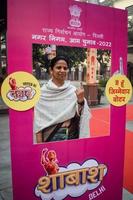 New Delhi, India - December 04 2022 - Unidentified people showing their ink-marked fingers after casting votes in front of polling booth of east Delhi area for MCD local body Elections 2022 photo