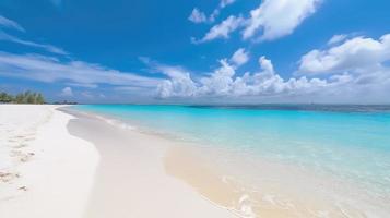 Beautiful sandy beach with white sand and rolling calm wave of turquoise ocean on Sunny day on background white clouds in blue sky. colorful perfect panoramic natural landscape. photo