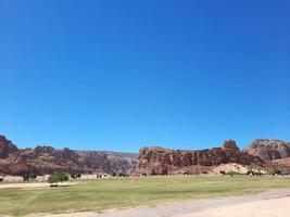 A beautiful daytime view of a winter park in Al Ula, Saudi Arabia. The park is surrounded by ancient hills. photo