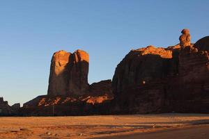 A beautiful daytime view of a winter park in Al Ula, Saudi Arabia. The park is surrounded by ancient hills. photo