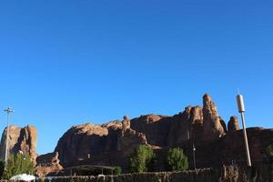 A beautiful daytime view of a winter park in Al Ula, Saudi Arabia. The park is surrounded by ancient hills. photo