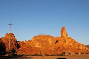 A beautiful daytime view of a winter park in Al Ula, Saudi Arabia. The park is surrounded by ancient hills. photo