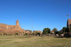 A beautiful daytime view of a winter park in Al Ula, Saudi Arabia. The park is surrounded by ancient hills. photo