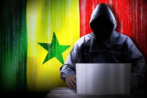 Anonymous Hooded Hacker and Flag Of Senegal, Binary Code - Cyber Attack Concept photo