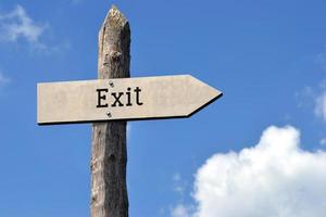 Exit - Wooden Signpost with one Arrow, Sky with Clouds photo