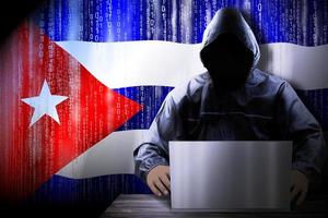 Anonymous Hooded Hacker and Flag Of Cuba, Binary Code - Cyber Attack Concept photo