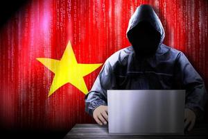 Anonymous Hooded Hacker and Flag Of Vietnam, Binary Code - Cyber Attack Concept photo