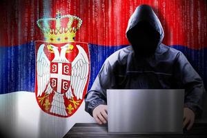 Anonymous Hooded Hacker and Flag Of Serbia, Binary Code - Cyber Attack Concept photo
