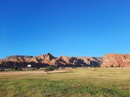 A beautiful daytime view of a winter park in Al Ula, Saudi Arabia. The park is surrounded by ancient hills. photo