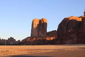 A beautiful daytime view of a winter park in Al Ula, Saudi Arabia. The park is surrounded by ancient hills. photo