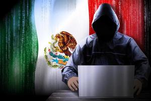 Anonymous Hooded Hacker and Flag Of Mexico, Binary Code - Cyber Attack Concept photo