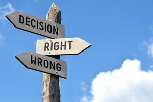 Decision, Right, Wrong - Wooden Signpost with Three Arrows photo