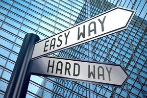 Easy or Hard Way - Signpost With Two Arrows, Office Building in Background photo