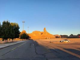 A beautiful daytime view of a winter park in Al Ula, Saudi Arabia. The park is surrounded by ancient hills. photo