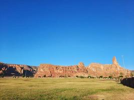 A beautiful daytime view of a winter park in Al Ula, Saudi Arabia. The park is surrounded by ancient hills. photo