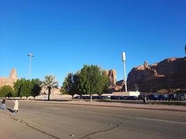 A beautiful daytime view of a winter park in Al Ula, Saudi Arabia. The park is surrounded by ancient hills. photo