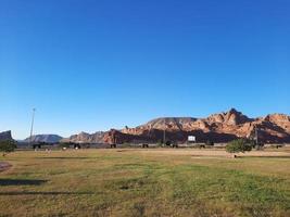 A beautiful daytime view of a winter park in Al Ula, Saudi Arabia. The park is surrounded by ancient hills. photo