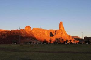 A beautiful daytime view of a winter park in Al Ula, Saudi Arabia. The park is surrounded by ancient hills. photo