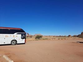 Al Ula, Saudi Arabia, March 2023 - Buses are parked at different places in the desert to take tourists to different places during the day in Al Ula, Saudi Arabia. photo