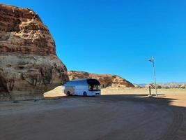 Al Ula, Saudi Arabia, March 2023 - Buses are parked at different places in the desert to take tourists to different places during the day in Al Ula, Saudi Arabia. photo