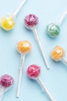 Sweet lollipops on blue background photo